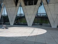 this is an image of a man riding a skateboard outside a building with a large window