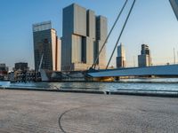 a woman riding a skateboard down a river next to a city dock in the background