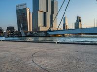 a woman riding a skateboard down a river next to a city dock in the background