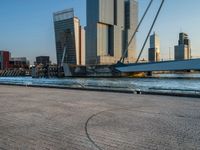 a woman riding a skateboard down a river next to a city dock in the background