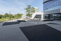 a view of an outside area of an office building with large windows and a circular driveway