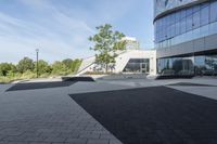 a view of an outside area of an office building with large windows and a circular driveway