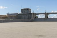 a couple of skate boards are standing near a concrete structure and under a blue sky