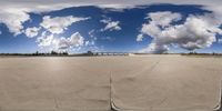 multiple pictures show a man jumping a skate board on the ground under some clouds in the sky