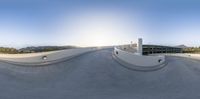 a view of the skateboard park from a fish eye view point at sunset as the sun sets