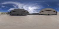 an upside down view of a skateboard park with circular designs and a blue sky