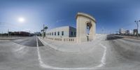 this time lapse of a skateboarder going up a ramp in front of an oval building