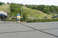 a person is riding on a skate board at a ski park with a blue umbrella