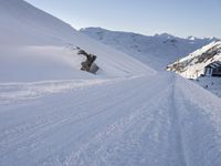 a snowboarder takes off into the snow as they make their way down a slope