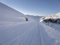 a snowboarder takes off into the snow as they make their way down a slope