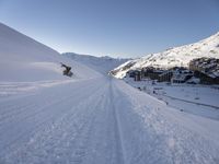 a snowboarder takes off into the snow as they make their way down a slope