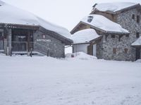 a person skiing down the snow covered slopes at a resort in the mountains outside of town