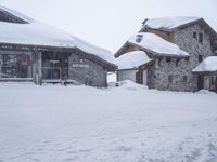 a person skiing down the snow covered slopes at a resort in the mountains outside of town