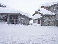 a person skiing down the snow covered slopes at a resort in the mountains outside of town