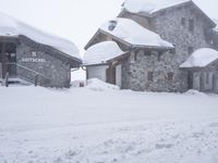 a person skiing down the snow covered slopes at a resort in the mountains outside of town