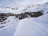 snow covered slope in the middle of a ski area as people ski on it near ski lift