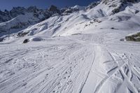 the ski slope has many tracks in it and skis along the side of it