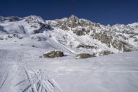 the ski slope has many tracks in it and skis along the side of it