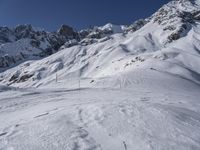 an image of a ski slope in the mountains covered in snow with a person on a skis