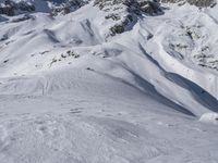 a skier on a snowy mountain side with snow surrounding him and several wires in the foreground