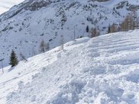 a man on skis is skiing down the side of a mountain in the snow