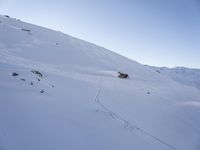 a person is skiing down the snow covered mountain slope, leaving trail markers and trails on the side of the hill