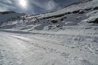 a person on skis is heading up a hill to a small cave in the snow