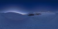 someone riding skis on a snow covered mountain under a bright sky at night,