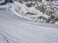 a man skiing down a steep mountain covered in snow and ice as viewed from the bottom