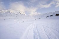 skis are lined up along the snowy slopes on a mountaintop with a ski lift in the background