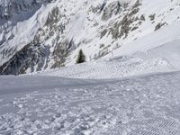 someone skiing down the snow covered slopes near large mountains in the background are the mountains