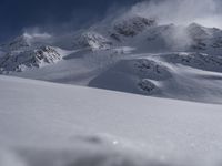 Skiing in the Alps: Clear Sky and Snowy Slopes