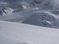 Skiing in the Alps: Clear Sky and Snowy Slopes