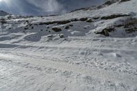 the person is skiing down the mountain slope on the snow road in front of him