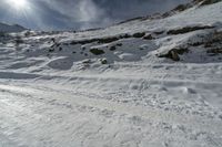 the person is skiing down the mountain slope on the snow road in front of him