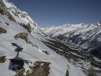 a snowboarder is skiing in the mountains with snowy peaks and mountains in the background