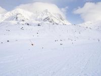 the skis are at the base of the slope line as they travel through the snow