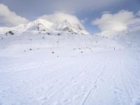 the skis are at the base of the slope line as they travel through the snow