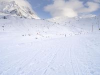 the skis are at the base of the slope line as they travel through the snow