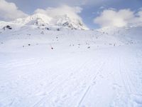 the skis are at the base of the slope line as they travel through the snow