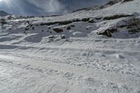 a person skiing down a snowy hill on skis through the snow in winter weather