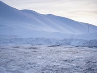 a group of people are skiing down a snowy mountain side line at sunset to ski