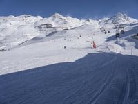 the snow is white and full of people skiing down a hill side near a lift