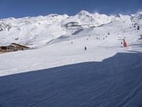 the snow is white and full of people skiing down a hill side near a lift