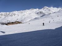 the snow is white and full of people skiing down a hill side near a lift