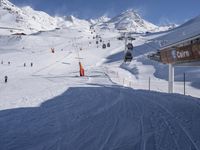 the snow is white and full of people skiing down a hill side near a lift