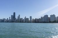 the large body of water near many city buildings and a beach on each side of it