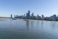 the large body of water near many city buildings and a beach on each side of it