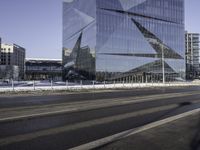 the buildings are in a large city in front of a street that has a curve