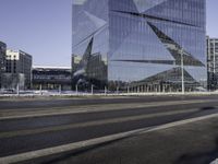 the buildings are in a large city in front of a street that has a curve